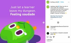Duolingo's green owl mascot lies down with teary eyes against a purple background, accompanied by the text 'Just let a learner leave my dungeon. Feeling saudade.' The image is part of Duolingo India's #EnglishMeinNahiJamta campaign, which emphasizes the untranslatable emotions conveyed through certain words, such as the Portuguese term 'Saudade,' which signifies a deep emotional state of longing or nostalgia